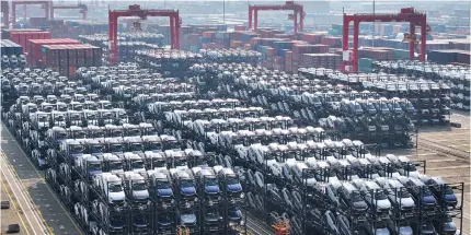  ?? Photo by AFP ?? BYD electric cars waiting to be loaded onto a ship are seen stacked at the internatio­nal container terminal of Taicang Port in Suzhou, in China’s eastern Jiangsu province on February 8, 2024.