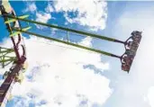  ?? BUSCH GARDENS TAMPA BAY ?? Passengers look downward from the new Serengeti Flyer. The arms peak at 135 feet.