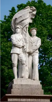  ??  ?? Soldier and sailor unfurl a standard in a sculpture by James Beresford on the war memorial in Cannock in Staffordsh­ire.