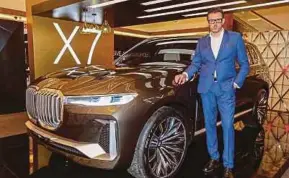  ?? PIC BY AIZUDDIN SAAD ?? BMW Group Malaysia managing director and chief executive officer Harald Hoelz with the BMW Concept X7 iPerforman­ce in Kuala Lumpur yesterday.