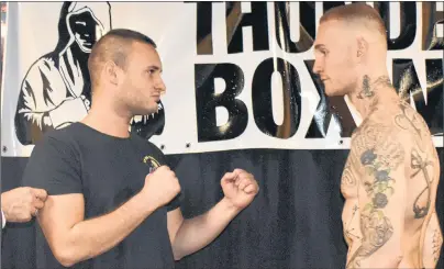 ?? CHRISTIAN ROACH/CAPE BRETON POST ?? Kristof Demendi, left, from Slovakia, and Cape Breton boxer Ryan Rozicki are seen squaring off at the weigh-ins at Boston Pizza in Sydney on Friday evening. The two will meet tonight as the headliners in an eight-bout card at Centre 200 in Sydney.