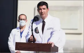  ?? Evan Vucci / Associated Press ?? Dr. Sean Conley, physician to President Donald Trump, talks with reporters at Walter Reed National Military Medical Center on Monday.