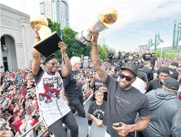  ?? AP ?? Raptors guard Kyle Lowry, left, and forward Kawhi Leonard during the team’s victory parade in Toronto on Monday.