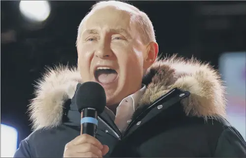  ??  ?? Russian President Vladimir Putin speaks at a rally as an exit poll suggests he has won a fourth term leading the world’s largest country.