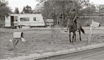  ?? Eric Gay photos / Associated Press ?? A boy rides a horse through Indian Hills East colonia near Alamo. Texas has more than 2,300 colonias.