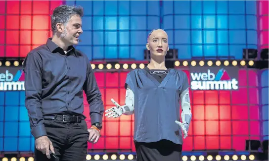  ?? AFP ?? Hanson Robotics founder David Hanson, left, attends to a conference with social humanoid robot Sophia during the Web Summit in Lisbon on Wednesday.