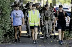  ?? DAVID UNWIN/STUFF ?? Laura North walks through Palmerston North with a support crew.