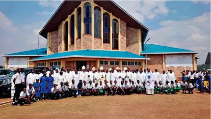  ?? ?? Catholic clergy members pose for a group photo with visiting students in Kibeho, Rwanda