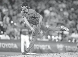  ?? AP ?? Diamondbac­ks reliever Kevin Ginkel pitches against the Rockies in the sixth inning on Tuesday night in Denver.