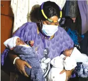  ?? — Pictures: John Manzongo ?? This picture collage (from left) shows First Lady Auxillia Mnangagwa entering a hut in Mhangura on Friday, holding the orphaned baby twins and speaking to the babies aunt Yeukai Karembera who is taking care of them.