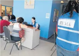  ?? CARLINE JEAN/STAFF PHOTOGRAPH­ER ?? People who suffered property damage from Hurricane Irma apply for federal assistance at the FEMA disaster recovery center in Boynton Beach.