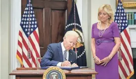  ?? PABLO MARTINEZ MONSIVAIS/AP ?? President Joe Biden signs into law the Bipartisan Safer Communitie­s Act gun safety bill Saturday at the White House. First lady Jill Biden, a teacher, also attended the signing ceremony.