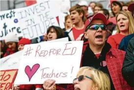  ?? David Zalubowski / Associated Press ?? Clark Wilhelm, who works in the Douglas County, Colo., school system, cheers during a teachers rally over low salaries and education cuts Thursday in Denver.