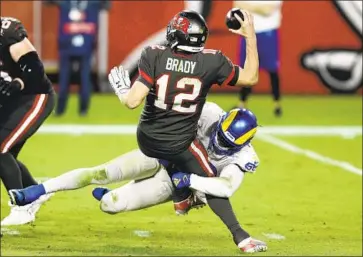  ?? Jason Behnken Associated Press ?? RAMS OUTSIDE LINEBACKER Samson Ebukam sacks Buccaneers quarterbac­k Tom Brady during the second half Monday night. Brady f inished 26 for 48 for 216 yards and two touchdowns with two intercepti­ons.