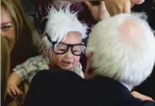  ?? | EVANVUCCI/AP ?? Democratic presidenti­al candidate Sen. Bernie Sanders meets 3-monthold Oliver Jack Carter Lomas-Davis, who was dressed as Sanders during a rally at Bonanza High School in LasVegas in February.