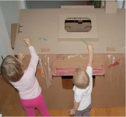  ?? PICTURES: MYBUSYCHIL­DREN. ?? OLD-FASHIONED MAGIC: A den made out of cardboard serves as a wonderful place for kids to hide, whisper, giggle and make-believe.