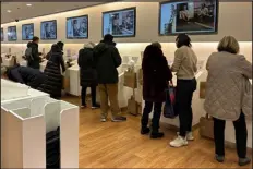  ?? ANNE D’INNOCENZIO — THE ASSOCIATED PRESS ?? Shoppers at a Uniqlo store in New York use self- checkout on Dec. 6.