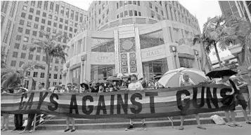  ?? RICARDO RAMIREZ BUXEDA/STAFF PHOTOGRAPH­ER ?? Rallygoers and speakers at the Honor Them with Action Pulse rally Monday in front of Orlando City Hall call for action on gun safety legislatio­n, LGBTQ civil rights and mental health funding.