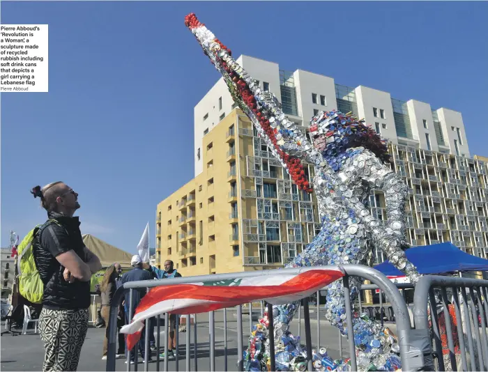  ?? Pierre Abboud ?? Pierre Abboud’s ‘Revolution is a Woman’, a sculpture made of recycled rubbish including soft drink cans that depicts a girl carrying a Lebanese flag