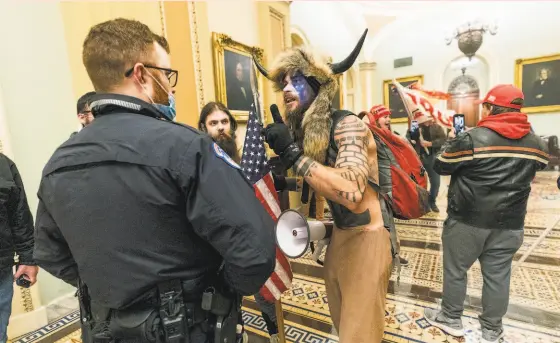  ?? Manuel Balce Ceneta / Associated Press ?? Capitol Police officers confront supporters of President Trump who invaded the U.S. Capitol and disrupted Congress on Jan. 6.