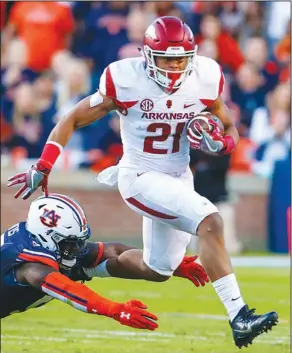  ?? Associated Press ?? On the move: In this Oct. 22, 2016, file photo, Arkansas running back Devwah Whaley (21) tries to elude the tackle of Auburn linebacker Deshaun Davis (57) during the first half of a game in Auburn, Ala. Arkansas was expected to have one of the most...