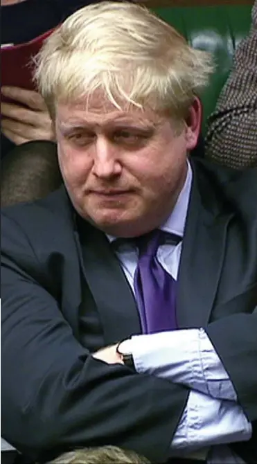  ??  ?? Scowling: Boris Johnson listens to the Prime Minister from the backbenche­s yesterday