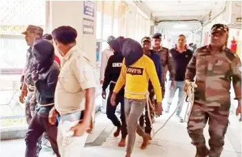  ?? — AFP photo ?? File photo shows police personnel escorting men accused for allegedly carrying out a brutal assault on a Spanish woman, to a district court in Dumka, in India’s Jharkhand state. Five more men have been arrested in connection with the assault.