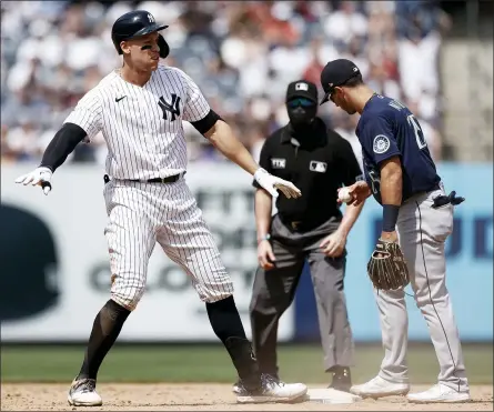  ?? ADAM HUNGER - THE ASSOCIATED PRESS ?? New York Yankees designated hitter Aaron Judge, left, reacts as he is safe at second base ahead of a tag by Seattle Mariners shortstop Dylan Moore, right, during the fourth inning of a baseball game on Saturday, Aug. 7, 2021, in New York.