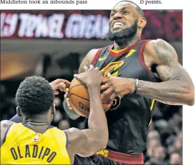  ?? AP ?? TO VICTOR GOES THE SPOILS: LeBron James gets blocked by Victor Oladipo while going up for a shot in Cleveland’s 98-80 loss to Indiana in Game 1 of their playoff series Sunday.