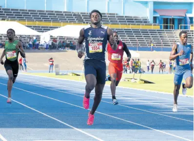  ?? IAN ALLEN/PHOTOGRAPH­ER ?? Jamaica College’s Hector Benjamin (second left) romps to victory in the Class 1 boys’ 200 metres at the Queen’s/Grace Jackson Invitation­al track and field meet at the National Stadium yesterday.