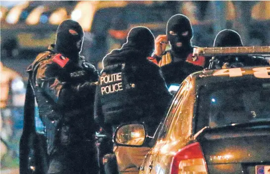  ?? Photo: REUTERS ?? Belgian special police forces take part in an operation in the neighbourh­ood of Molenbeek in Brussels.