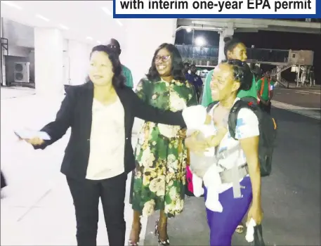  ??  ?? Minister of State Dawn Hastings (left) welcomes home Hurricane Dorian survivor Mrs Grimmond and her infant at the Cheddi Jagan Internatio­nal Airport, Timehri last night as Minister of Foreign Affairs Dr Karen Cummings looks on.