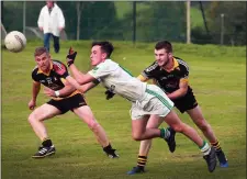  ??  ?? Oran Maddock of Crossabeg-Ballymurn is tracked by Realt na Mara duo, Colm Cosgrave and Darren Morris.