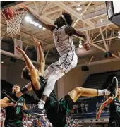  ?? Tim Warner ?? A Utah Valley defender has nowhere to go as Rice’s Marquez Letcher-Ellis (12) wraps him up and slams home two of his 12 points in the first half.