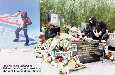  ?? ?? Flowers were placed at Birkan Uzun's grave, next to a photo of him on Mount Vinson