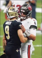  ?? Butch Dill / Associated Press ?? Future Hall of Fame quarterbac­ks Drew Brees of the Saints, left, and Tom Brady of the Buccaneers will meet Sunday in New Orleans in the NFL playoffs.