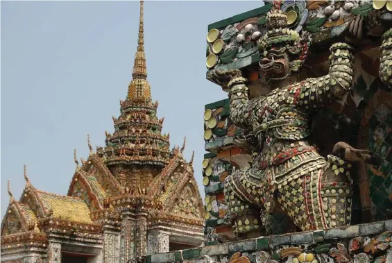  ?? Susan Hegger/St. Louis Post-Dispatch/TNS ?? At Wat Arun in Bangkok, Thailand, pieces of porcelain adorn the temples and the mythologic­al creatures lining the facade.