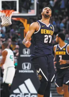  ?? David Zalubowski / Associated Press ?? Denver guard Jamal Murray exults after driving the lane for a basket against the Celtics in the second half.