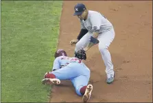  ?? MATT SLOCUM - THE ASSOCIATED PRESS ?? Phillies outfielder Andrew McCutchen, left, is tagged out by New York Yankees second baseman Gleyber Torres in the third inning Thursday night. Phils manager Joe Girardi believes McCutchen is right for the leadoff spot even though he has gotten off to a slow start.