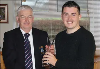  ??  ?? Enda O’Halloran collecting his 2017 Golfer of the Year trophy from Club Captain Jack Dempsey at the Presentati­on of Prizes at Ballyheigu­e Castle Golf Club on Sunday last