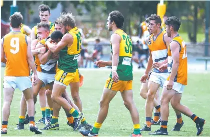  ??  ?? Korumburra-Bena’s Daniel Abou-Karroum finds himself wrapped up by a wall of Garfield players, met front on by Stars player Saxon Watson.