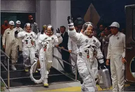  ?? THE ASSOCIATED PRESS FILE ?? From right, Neil Armstrong, Michael Collins and Buzz Aldrin walk to the van that will take them to the launchpad at Kennedy Space Center on Merritt Island, Fla., on July 16, 1969.