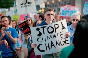  ?? AFP ?? Demonstrat­ors protest President Donald Trump’s decision to exit the Paris climate change accord in Chicago, Illinois. —