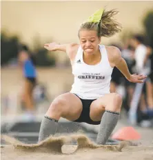  ?? CRAIG FRITZ/FOR THE NEW MEXICAN ?? Santa Fe Prep’s Hayden Colfax completes her jump during the Golden Spike Classic. Colfax won the event with a personal best 34-4½.