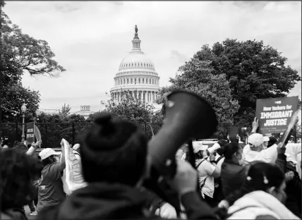  ?? STEFANI REYNOLDS / THE NEW YORK TIMES ?? Demonstrat­ors march May 12 past the U.S. Capitol while protesting immigratio­n reform. House Democrats, who led an angry charge against the Trump administra­tion’s treatment of migrant children, have taken a much quieter tack since concerns began emerging about conditions at some of the emergency shelters set up by the Biden administra­tion to deal with minors at the southern border.