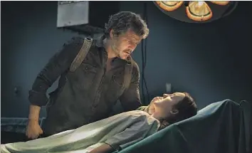  ?? Liane Hentscher HBO ?? JOEL (Pedro Pascal) comforts Ellie (Bella Ramsey) at a medical facility in season finale of “The Last of Us.”