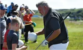  ??  ?? Darren Clarke signs autographs during a practice round prior to the Open Championsh­ip at Royal Portrush. Photograph: Warren Little/R&A/R&A via Getty Images
