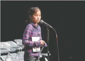  ?? STAFF FILE PHOTO BY DOUG STRICKLAND ?? Thrasher Elementary School student Lisa Lin spells a word during The Times Free Press Regional Spelling Bee on Saturday. She went on to win first place.