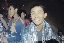  ?? THE ASSOCIATED PRESS ?? In this image taken from video provided by the Royal Thai Navy Facebook page, a Thai boy smiles as Thai navy SEAL medics help injured children trapped inside a cave in Mae Sai, northern Thailand.