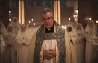  ?? ANTHONY ELLISON — IFC MIDNIGHT ?? Danny Huston as Father Romero in Christophe­r Smith’s “Consecrati­on.”